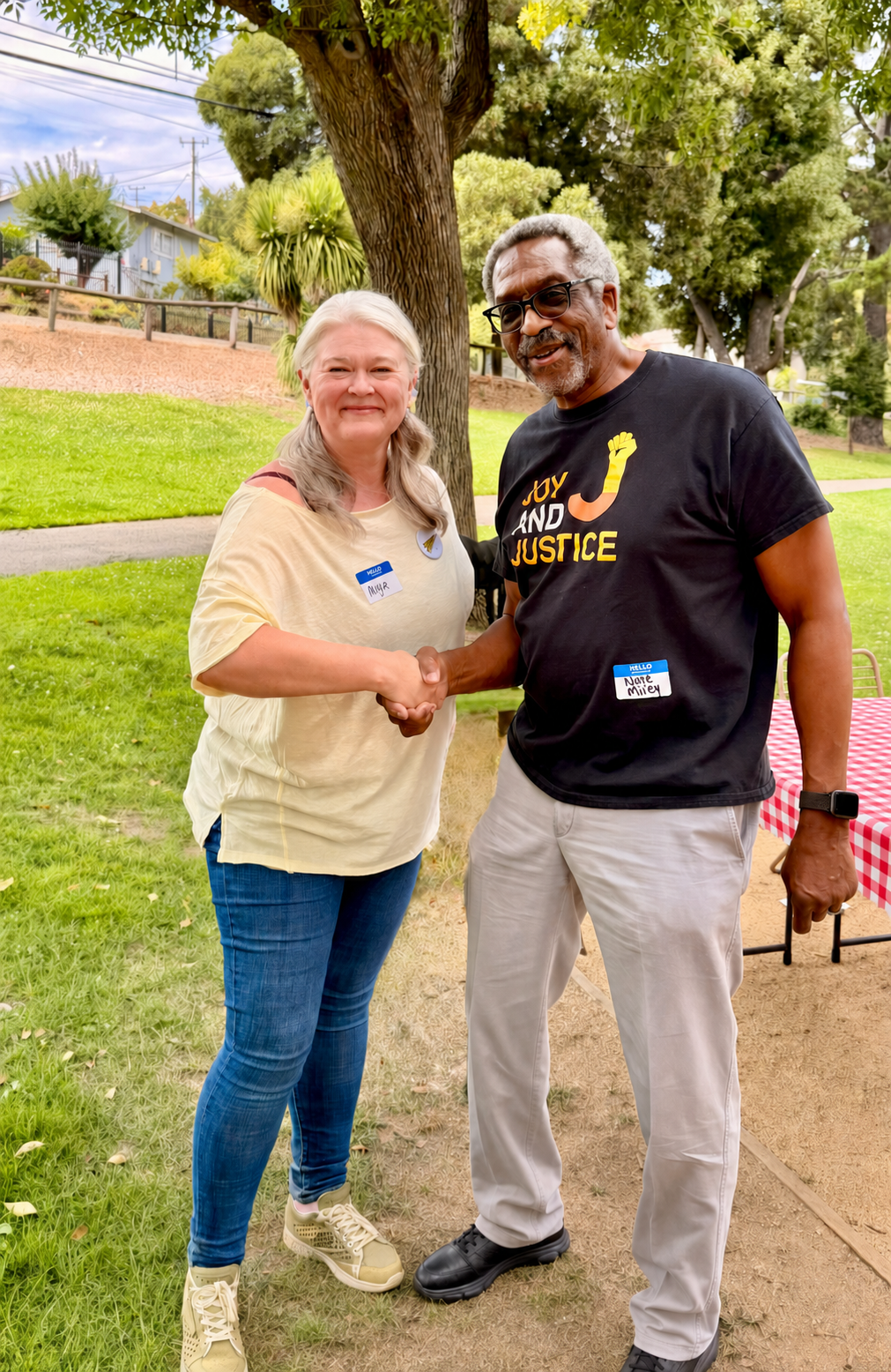 Myla Long greeting a community member at a local event